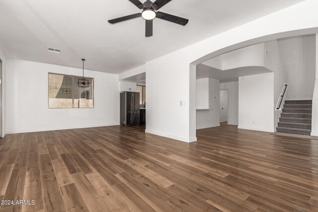 unfurnished living room featuring ceiling fan and wood-type flooring