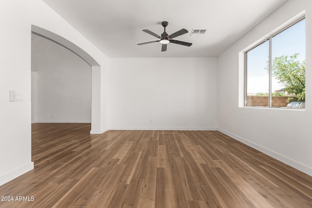 empty room with ceiling fan and wood-type flooring