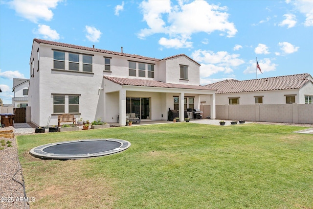 3919 W Abalone Ln, San Tan Valley, AZ 85144 - rear view of house with a trampoline, a tiled roof, stucco siding, and a patio