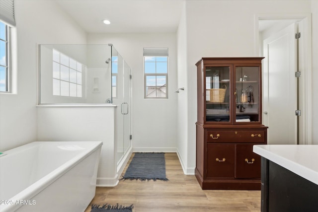 3919 W Abalone Ln, San Tan Valley, AZ 85144 - full bath with a stall shower, a freestanding tub, vanity, wood finished floors, and recessed lighting