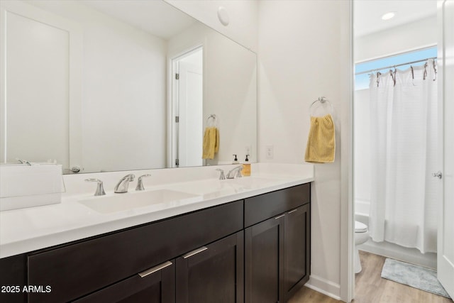 3919 W Abalone Ln, San Tan Valley, AZ 85144 - full bathroom featuring double vanity, wood finished floors, toilet, shower / bathtub combination with curtain, and recessed lighting