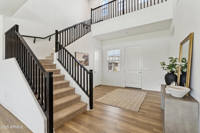 3919 W Abalone Ln, San Tan Valley, AZ 85144 - entryway with stairway, wood finished floors, and a towering ceiling