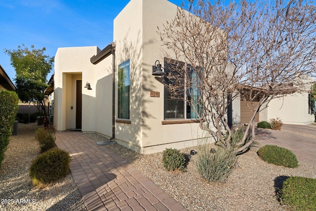 exterior space featuring driveway and stucco siding