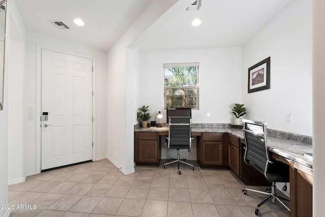 office area with light tile patterned floors, built in desk, visible vents, and recessed lighting