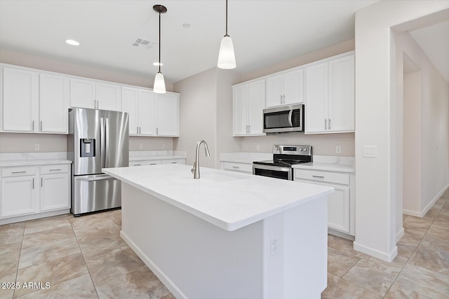 12727 W Lowden Rd, Peoria, AZ 85383 - kitchen featuring stainless steel appliances, a sink, white cabinetry, an island with sink, and recessed lighting