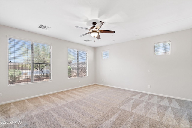 12727 W Lowden Rd, Peoria, AZ 85383 - spare room featuring a ceiling fan, light carpet, and baseboards