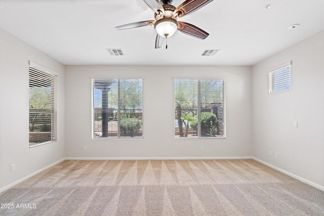 12727 W Lowden Rd, Peoria, AZ 85383 - spare room featuring light carpet, baseboards, and a ceiling fan