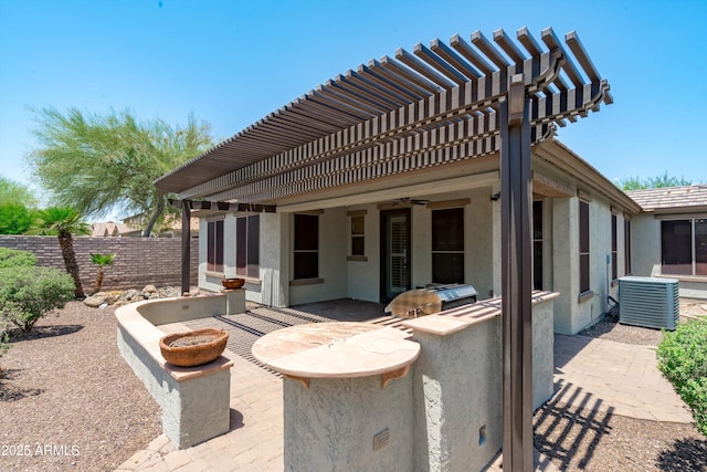 12727 W Lowden Rd, Peoria, AZ 85383 - fenced backyard with an outdoor kitchen, central AC unit, a patio area, and a pergola