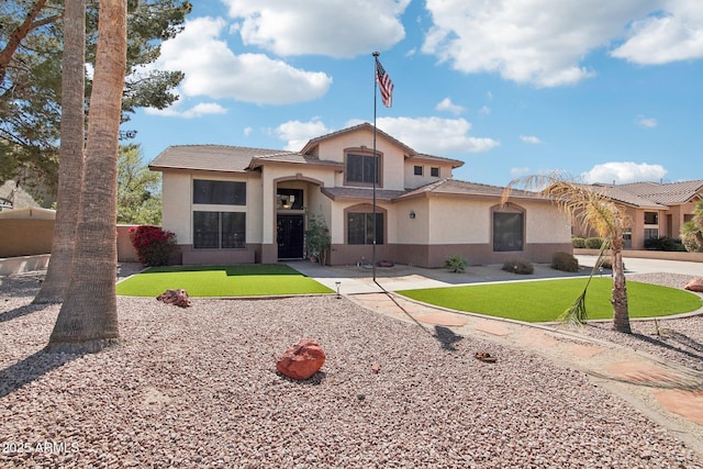 view of front of home featuring a front lawn, fence, and stucco siding