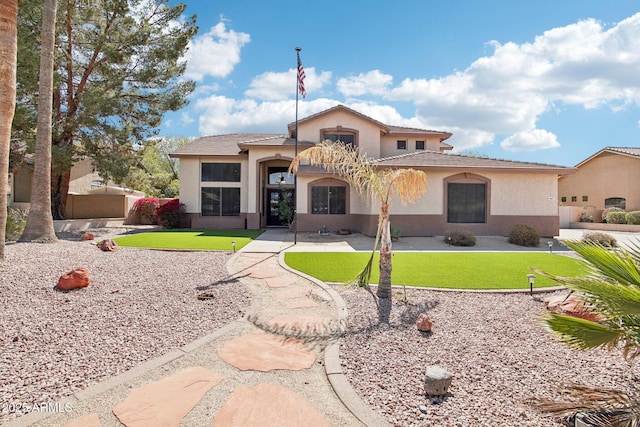 view of front of house with a front lawn and stucco siding