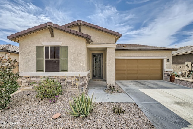 view of front of home featuring concrete driveway, an attached garage, stone siding, and stucco siding