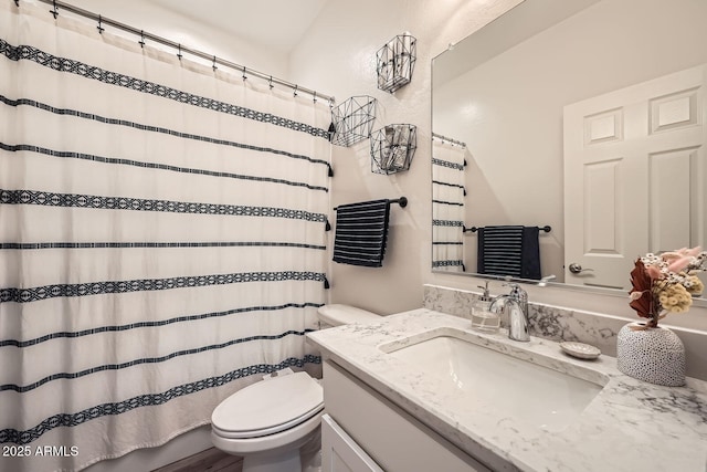 bathroom with a shower with curtain, vanity, and toilet