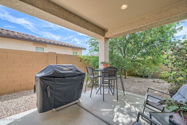 view of patio with a fenced backyard and a grill