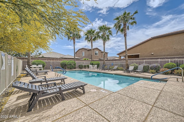 pool featuring fence and a patio