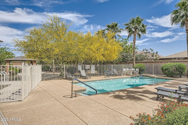 pool featuring fence and a patio area