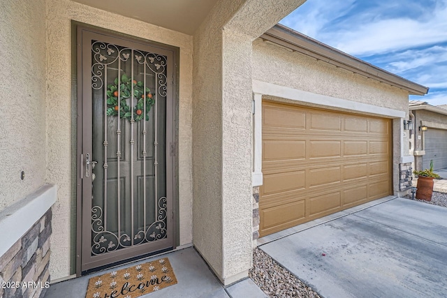 view of exterior entry featuring stucco siding