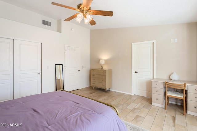 bedroom with visible vents, a ceiling fan, lofted ceiling, wood finish floors, and a closet