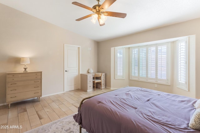 bedroom featuring vaulted ceiling, ceiling fan, light wood finished floors, and baseboards