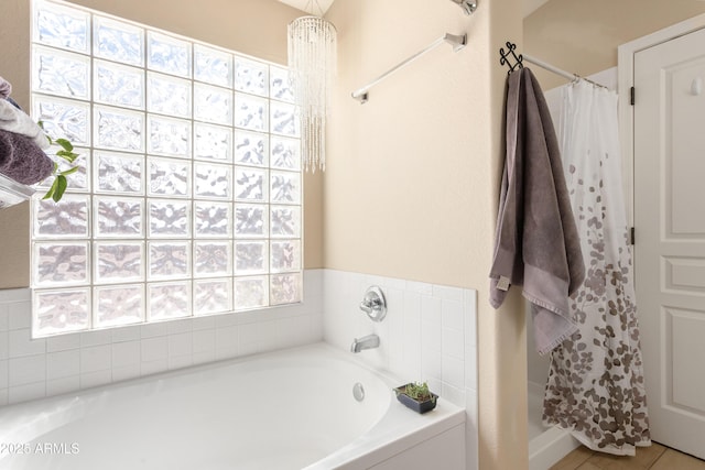 full bathroom featuring a garden tub and a shower stall