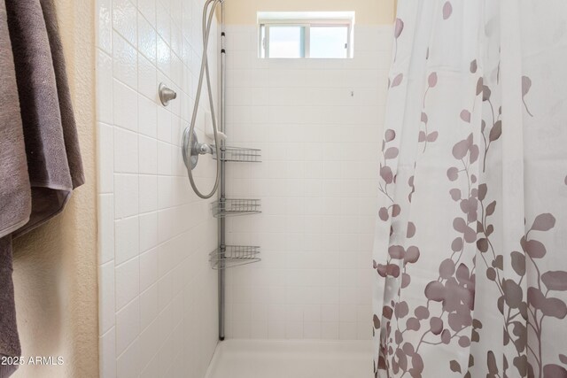 bathroom with tiled shower