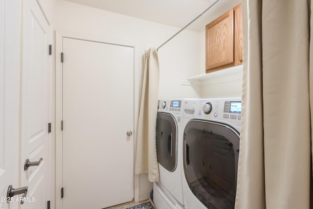 washroom with separate washer and dryer and cabinet space