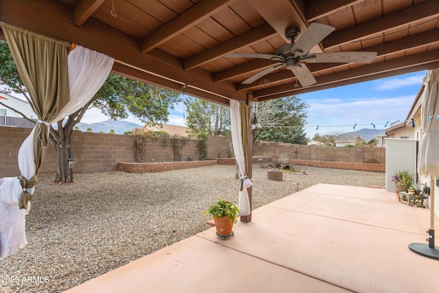 view of patio with a fenced backyard and ceiling fan