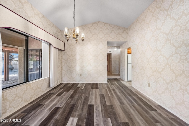 unfurnished dining area with dark hardwood / wood-style floors, lofted ceiling, and a notable chandelier