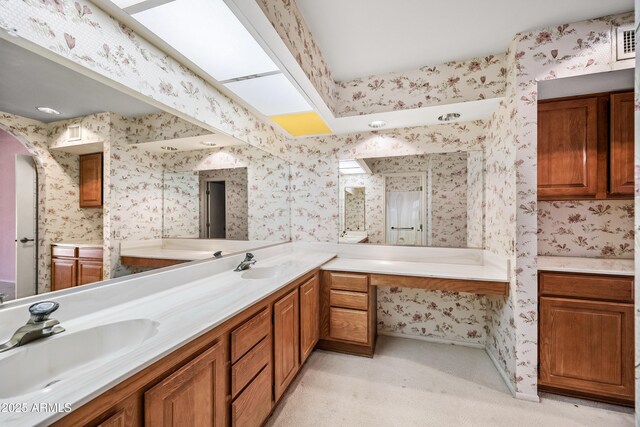 bathroom with vanity and a skylight