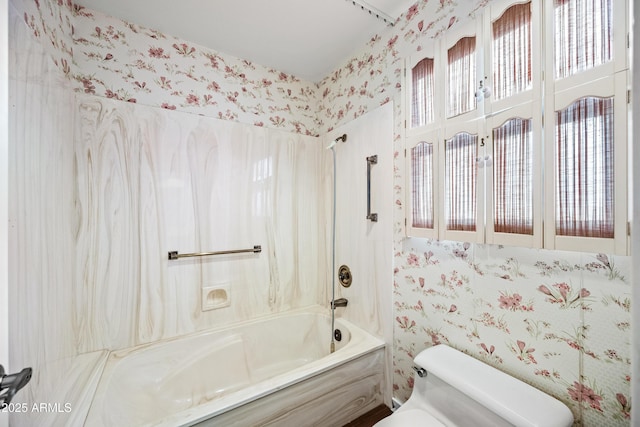 bathroom with shower / washtub combination and toilet