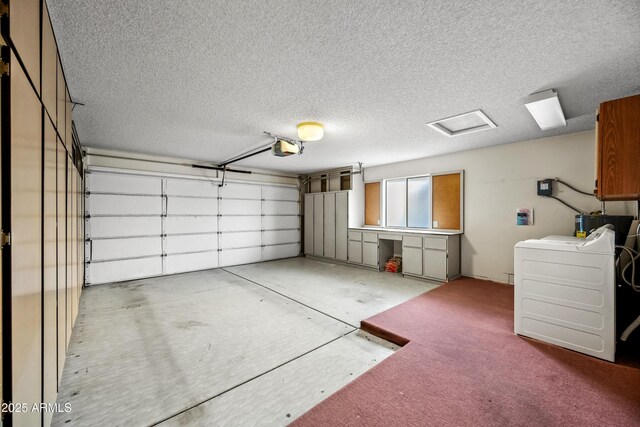 garage featuring a garage door opener and washer / dryer