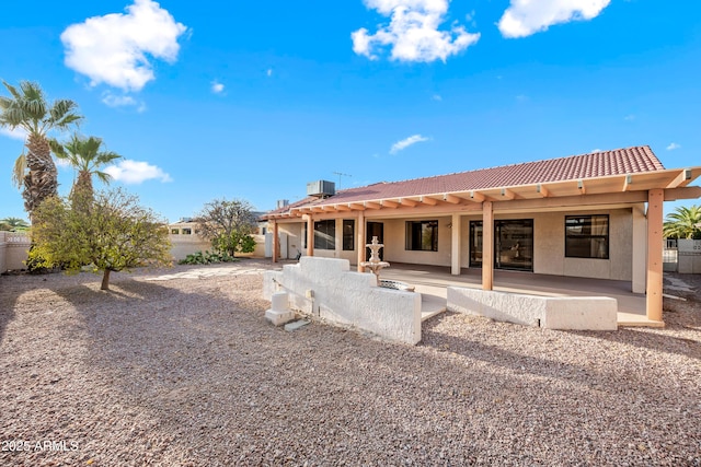 back of property featuring central air condition unit and a patio area