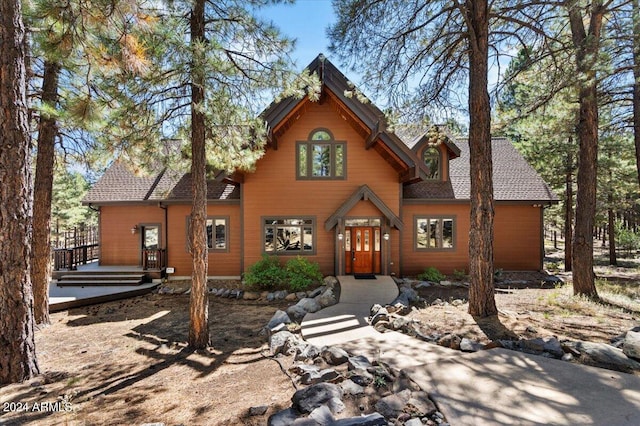 back of property with a wooden deck