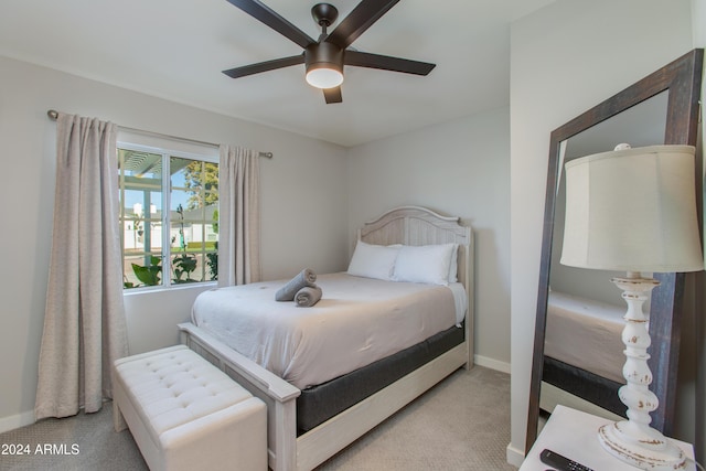 bedroom with light colored carpet and ceiling fan