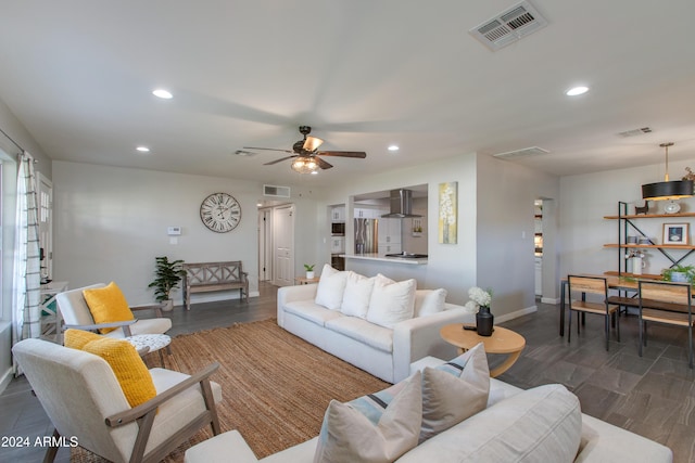 living room featuring ceiling fan and dark hardwood / wood-style flooring