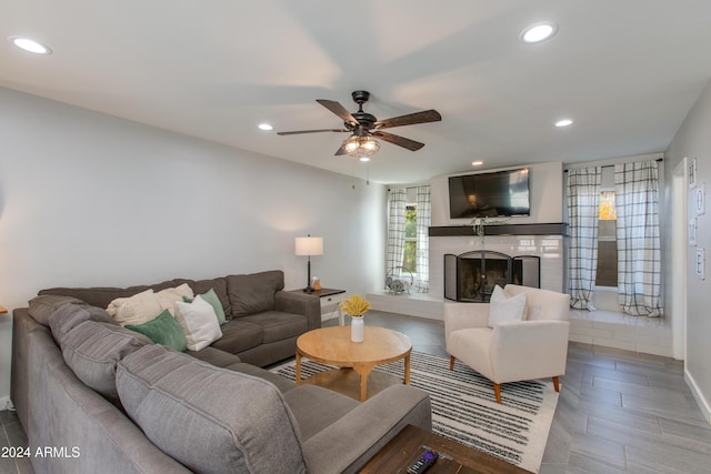 living room featuring ceiling fan and hardwood / wood-style floors