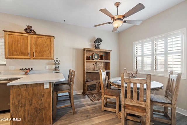 dining room featuring ceiling fan and dark wood-type flooring