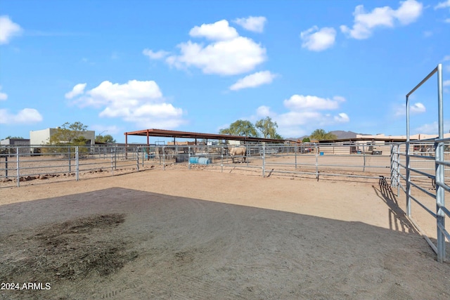 view of yard featuring a rural view and an outdoor structure