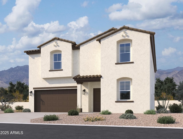 mediterranean / spanish-style home with concrete driveway, a mountain view, a garage, and stucco siding