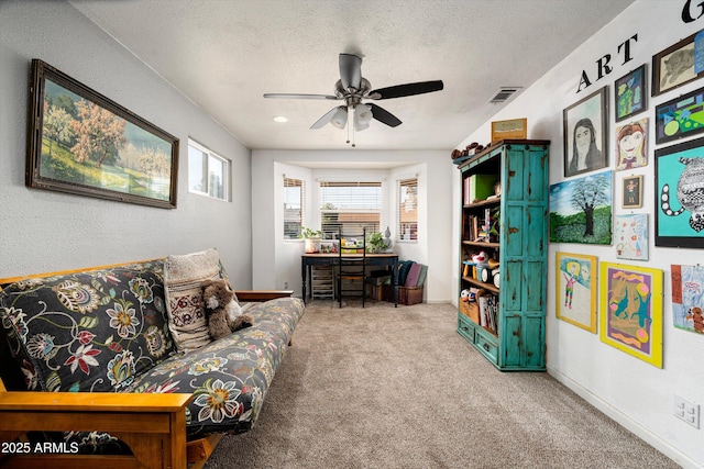 1027 E El Camino Dr, Phoenix, AZ 85020 - carpeted living room featuring a textured ceiling, ceiling fan, and baseboards