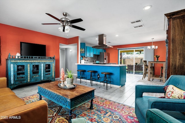 1027 E El Camino Dr, Phoenix, AZ 85020 - living area featuring ceiling fan, light wood-style flooring, a chandelier, and recessed lighting