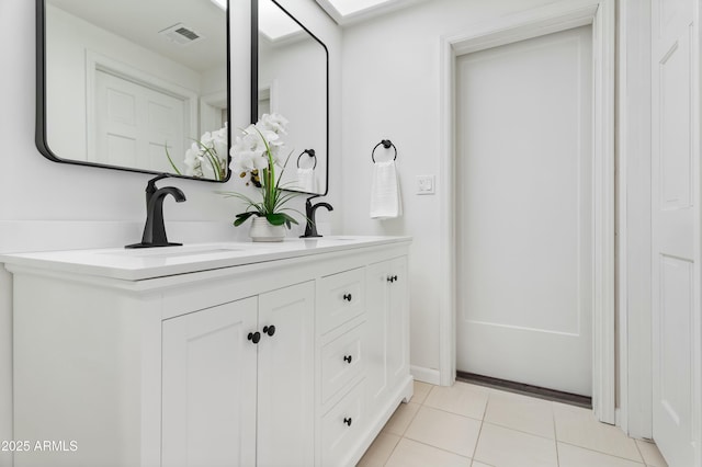 bathroom featuring tile patterned flooring and vanity