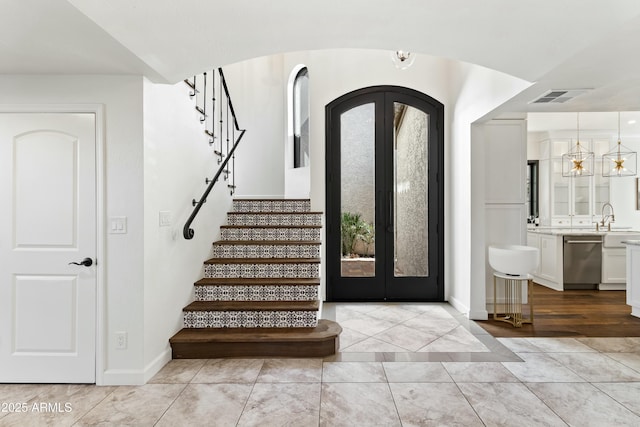 foyer featuring sink, plenty of natural light, and french doors