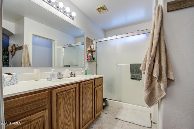 bathroom with vanity, a shower with shower door, and tile patterned flooring