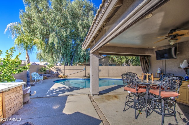 view of pool featuring ceiling fan and a patio area