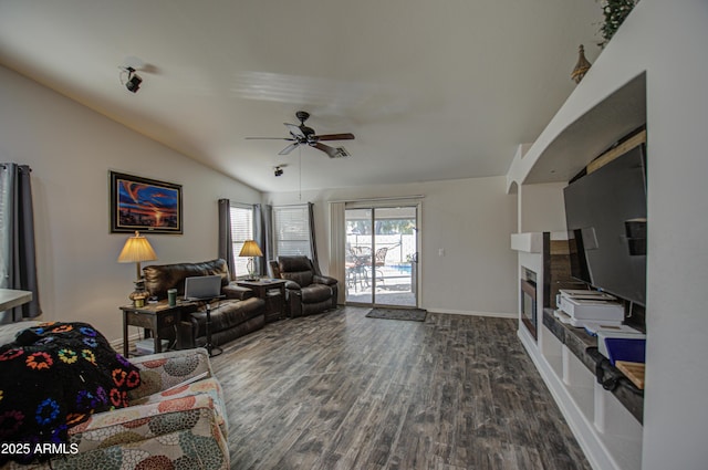 living room with ceiling fan, lofted ceiling, and dark hardwood / wood-style flooring