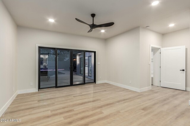 empty room featuring ceiling fan and light hardwood / wood-style flooring