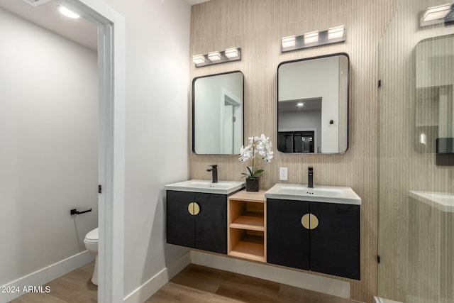 bathroom with decorative backsplash, wood-type flooring, toilet, and vanity