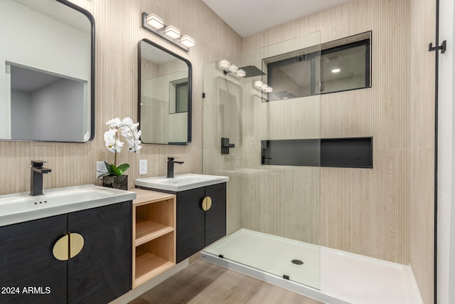 bathroom with vanity, hardwood / wood-style flooring, backsplash, and walk in shower