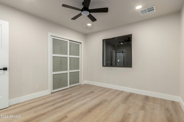 empty room featuring ceiling fan and light hardwood / wood-style floors