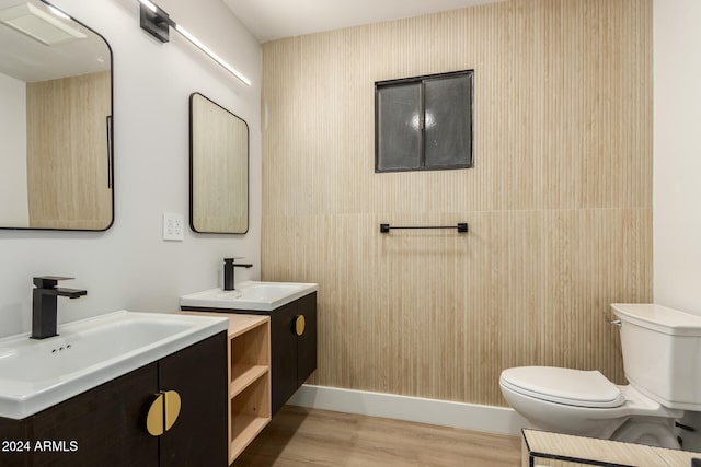 bathroom with toilet, vanity, and hardwood / wood-style floors